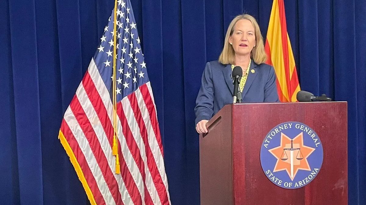 Arizona Attorney General Kris Mayes speaks at podium with U.S. and Arizona flags.